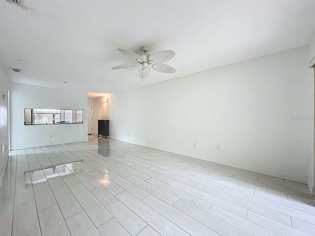 6140 Burnside Cir Unit 204, Orlando, FL 32822 - spare room featuring a ceiling fan and a textured ceiling