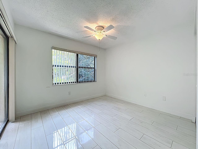 6140 Burnside Cir Unit 204, Orlando, FL 32822 - empty room with a textured ceiling, ceiling fan, and light wood-style flooring