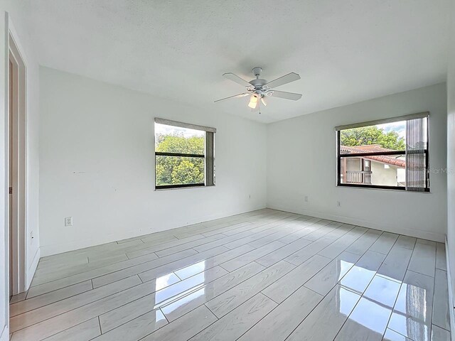 6140 Burnside Cir Unit 204, Orlando, FL 32822 - unfurnished room with healthy amount of natural light, wood tiled floors, and ceiling fan
