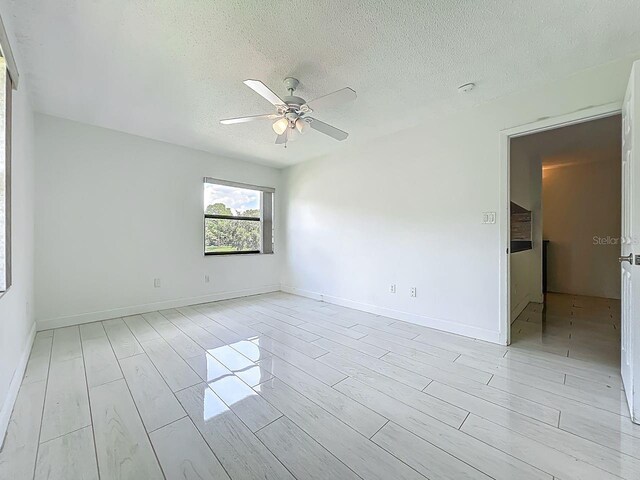 6140 Burnside Cir Unit 204, Orlando, FL 32822 - unfurnished room featuring ceiling fan, a textured ceiling, and wood tiled floors