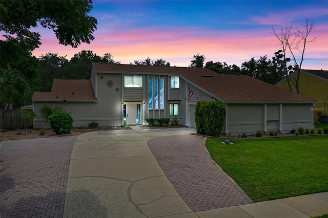 5630 Spring Run Ave, Orlando, FL 32819 - view of front of home featuring decorative driveway, a front lawn, and roof with shingles