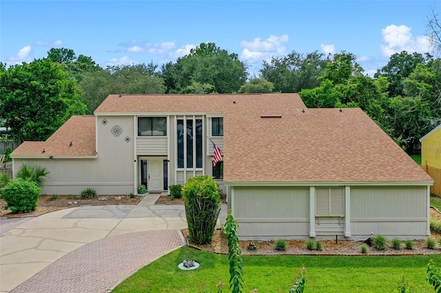 5630 Spring Run Ave, Orlando, FL 32819 - view of front of home featuring a shingled roof and a front lawn