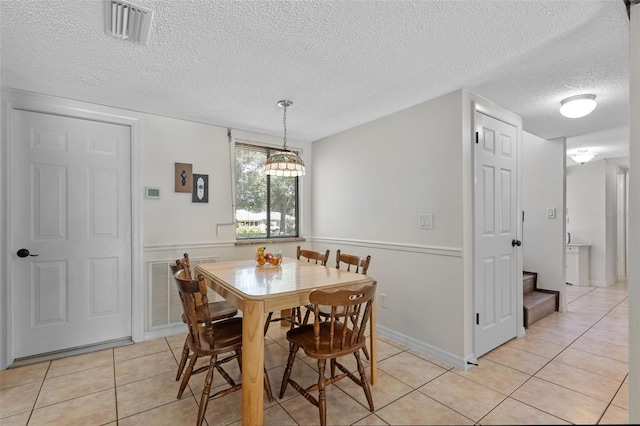 5630 Spring Run Ave, Orlando, FL 32819 - dining area featuring a textured ceiling and light tile patterned flooring