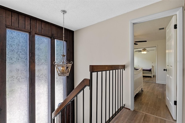 5630 Spring Run Ave, Orlando, FL 32819 - corridor with wood finished floors and a textured ceiling