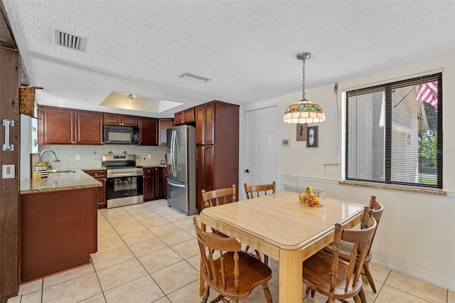 5630 Spring Run Ave, Orlando, FL 32819 - dining area featuring light tile patterned flooring and a textured ceiling