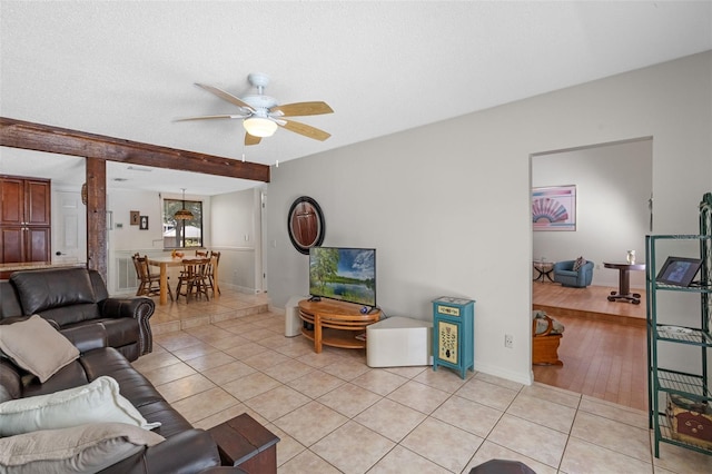 5630 Spring Run Ave, Orlando, FL 32819 - living area featuring ceiling fan, light tile patterned floors, and beamed ceiling