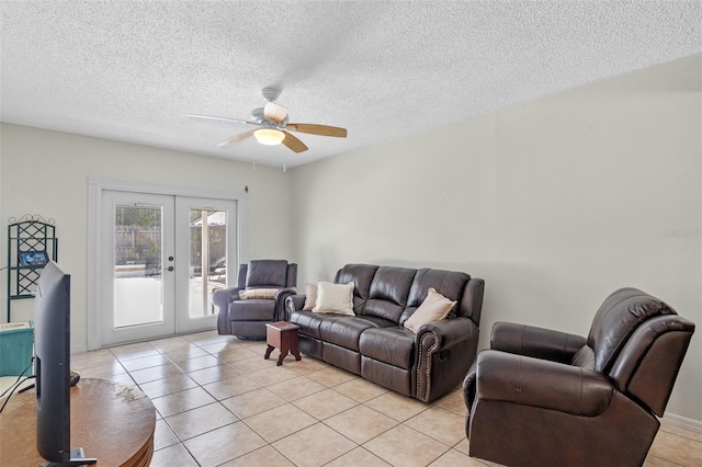5630 Spring Run Ave, Orlando, FL 32819 - living room featuring french doors, light tile patterned floors, a ceiling fan, and a textured ceiling