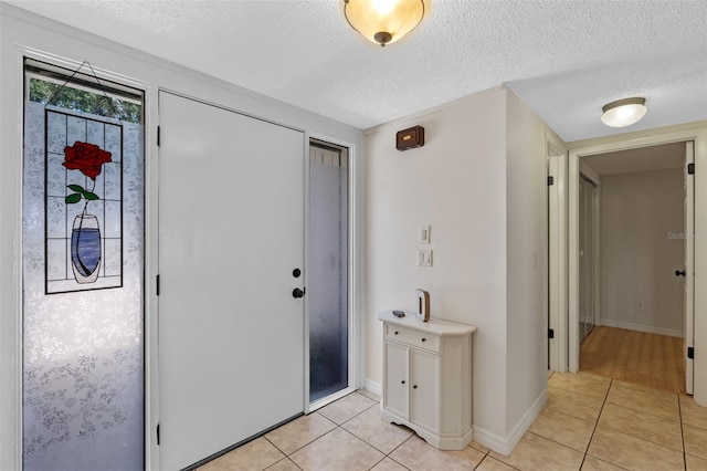 5630 Spring Run Ave, Orlando, FL 32819 - foyer featuring light tile patterned floors and a textured ceiling