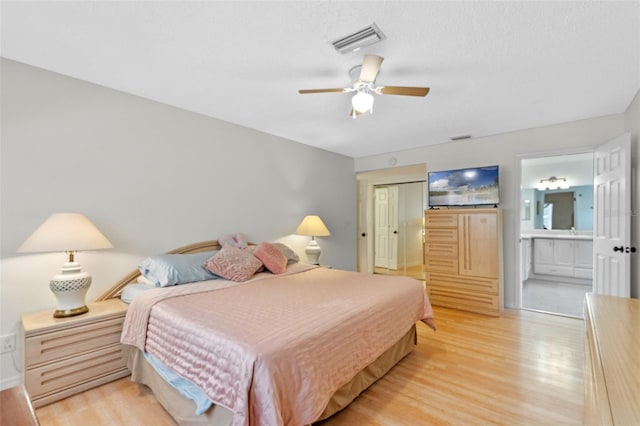 5630 Spring Run Ave, Orlando, FL 32819 - bedroom with light wood-style flooring, ensuite bathroom, a closet, and a ceiling fan