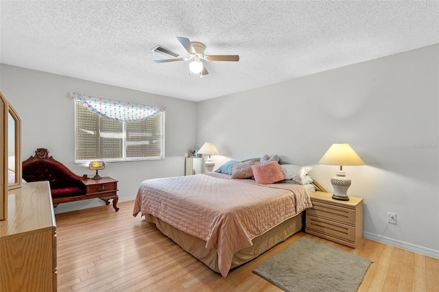 5630 Spring Run Ave, Orlando, FL 32819 - bedroom with light wood-style flooring, a textured ceiling, and ceiling fan
