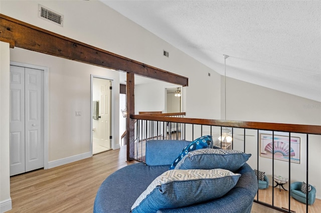 5630 Spring Run Ave, Orlando, FL 32819 - living area featuring vaulted ceiling, wood finished floors, and a textured ceiling