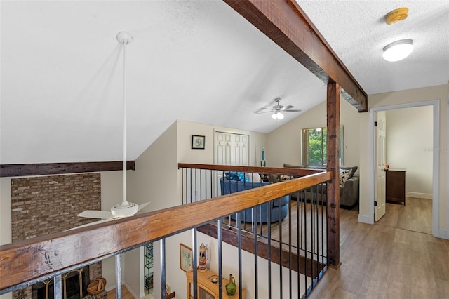 5630 Spring Run Ave, Orlando, FL 32819 - hall featuring light wood-type flooring, a textured ceiling, an upstairs landing, and vaulted ceiling