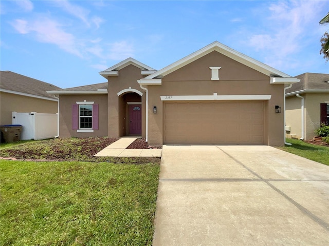 2587 Isabela Ter, Kissimmee, FL 34743 - view of front facade featuring stucco siding, an attached garage, concrete driveway, and a front yard