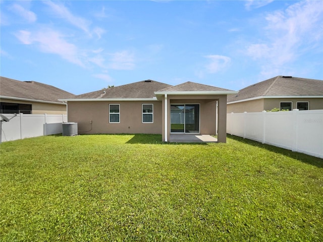 2587 Isabela Ter, Kissimmee, FL 34743 - back of house with a fenced backyard, stucco siding, a patio, and a shingled roof