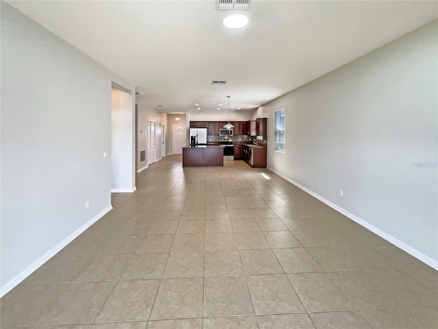 2587 Isabela Ter, Kissimmee, FL 34743 - unfurnished living room featuring light tile patterned flooring and recessed lighting