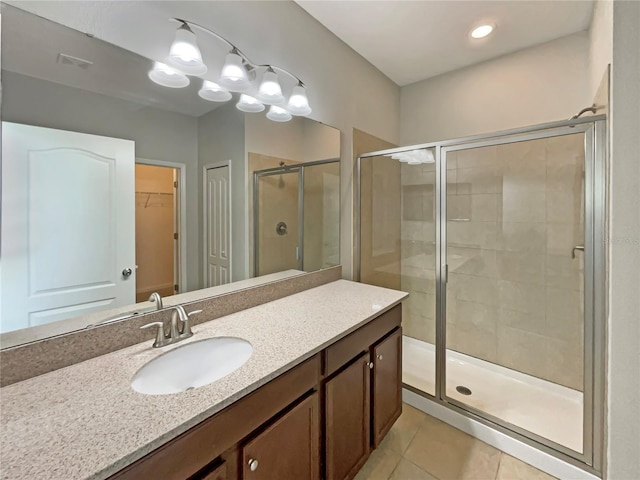 2587 Isabela Ter, Kissimmee, FL 34743 - bathroom with vanity, a stall shower, tile patterned flooring, and a walk in closet