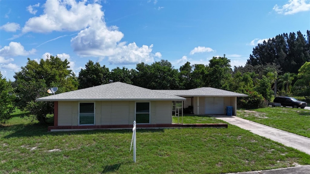 2967 Sailfish St NE, Palm Bay, FL 32905 - view of front facade featuring a front yard, concrete driveway, and a garage