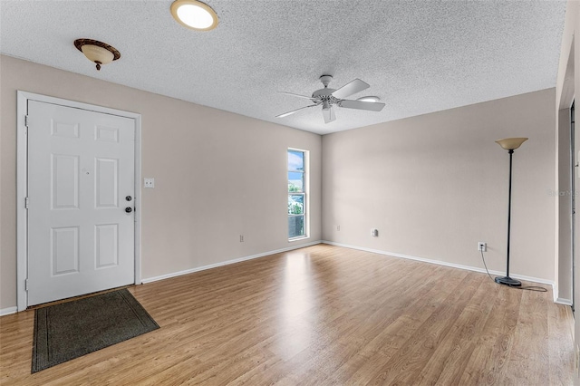 1384 La Paloma Cir, Winter Springs, FL 32708 - foyer with light wood finished floors, a ceiling fan, and a textured ceiling
