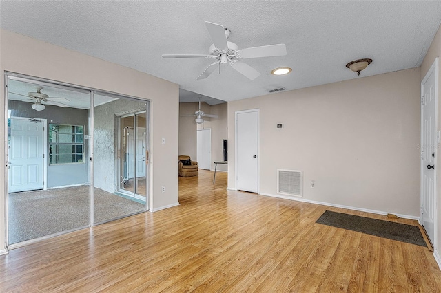 1384 La Paloma Cir, Winter Springs, FL 32708 - spare room featuring light wood-style floors, ceiling fan, and a textured ceiling