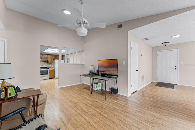 1384 La Paloma Cir, Winter Springs, FL 32708 - living room featuring light wood-style flooring, a ceiling fan, a textured ceiling, and recessed lighting