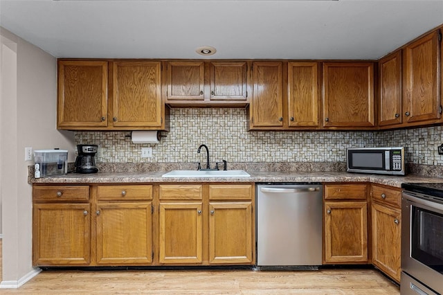 1384 La Paloma Cir, Winter Springs, FL 32708 - kitchen with stainless steel appliances, backsplash, and brown cabinetry