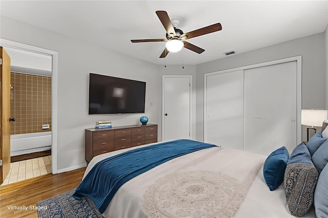 1384 La Paloma Cir, Winter Springs, FL 32708 - bedroom featuring wood finished floors, a closet, ensuite bath, and a ceiling fan