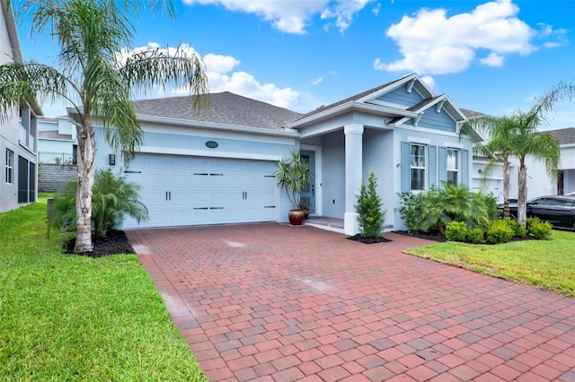 1219 Foltz Loop, Oakland, FL 34787 - view of front of home featuring stucco siding, an attached garage, decorative driveway, a front lawn, and roof with shingles