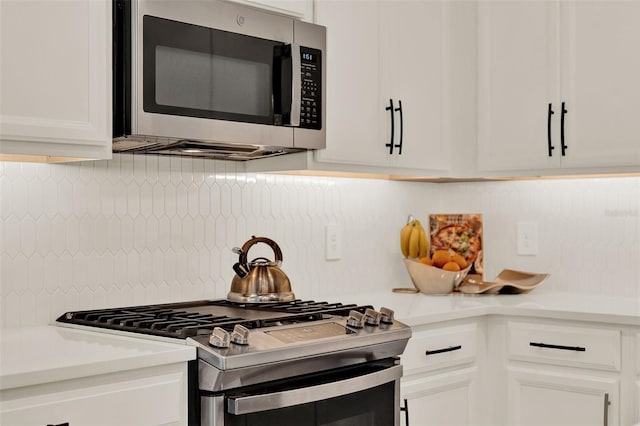 1219 Foltz Loop, Oakland, FL 34787 - kitchen featuring appliances with stainless steel finishes, white cabinetry, light countertops, and tasteful backsplash