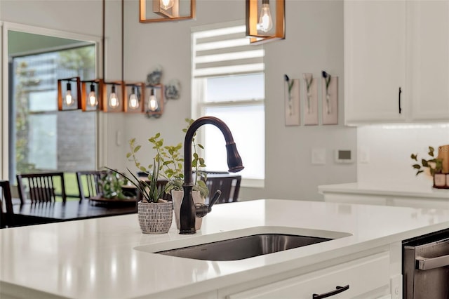 1219 Foltz Loop, Oakland, FL 34787 - kitchen view of stainless steel dishwasher, light countertops, and white cabinetry