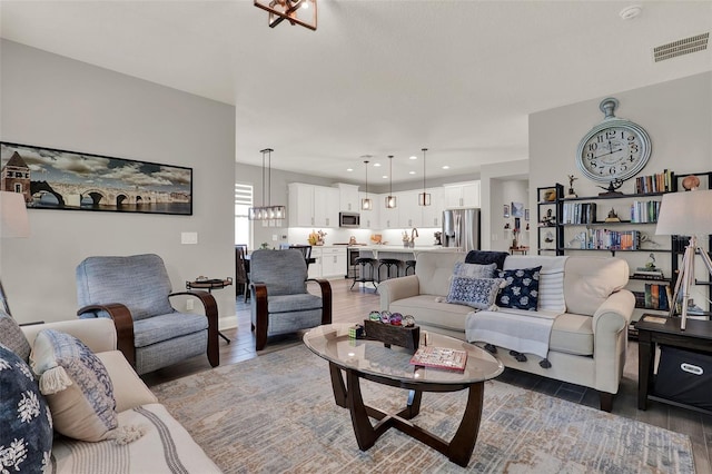 1219 Foltz Loop, Oakland, FL 34787 - living room with wood finished floors, a chandelier, and recessed lighting