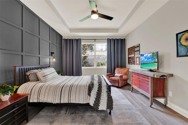 1219 Foltz Loop, Oakland, FL 34787 - bedroom with a raised ceiling, light wood finished floors, and a ceiling fan