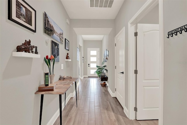 1219 Foltz Loop, Oakland, FL 34787 - hallway featuring light wood-type flooring and baseboards