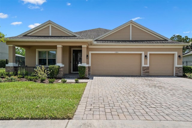 13851 Jomatt Loop, Winter Garden, FL 34787 - craftsman-style house with stucco siding, stone siding, and decorative driveway