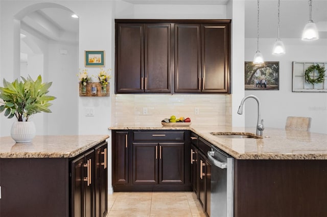13851 Jomatt Loop, Winter Garden, FL 34787 - kitchen with stainless steel dishwasher, tasteful backsplash, light stone countertops, and dark brown cabinetry