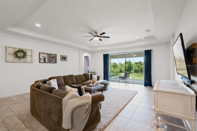 13851 Jomatt Loop, Winter Garden, FL 34787 - living area featuring a tray ceiling, light tile patterned flooring, a ceiling fan, recessed lighting, and arched walkways