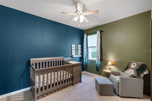 13851 Jomatt Loop, Winter Garden, FL 34787 - bedroom featuring light carpet, a nursery area, and a ceiling fan