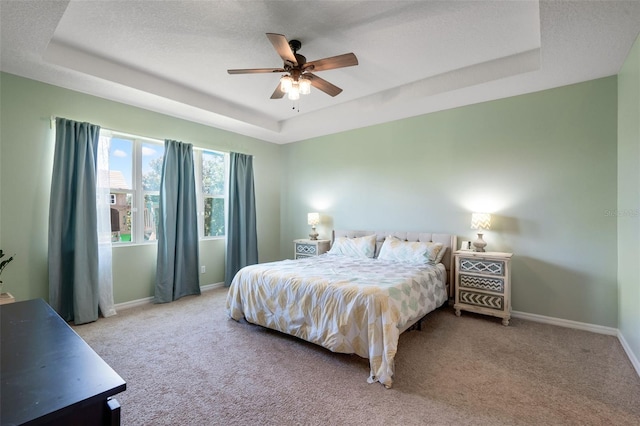 13851 Jomatt Loop, Winter Garden, FL 34787 - bedroom featuring a raised ceiling, carpet flooring, and a ceiling fan