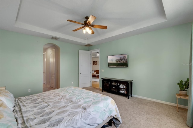 13851 Jomatt Loop, Winter Garden, FL 34787 - bedroom with a raised ceiling, arched walkways, light colored carpet, and ceiling fan