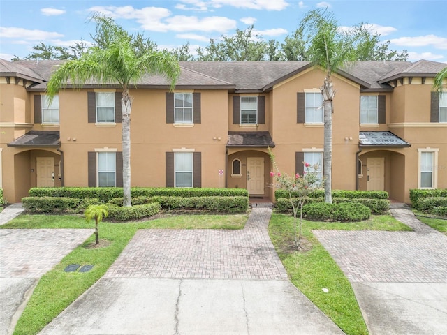 4224 Calabria Ave, Davenport, FL 33897 - view of property featuring stucco siding and a shingled roof