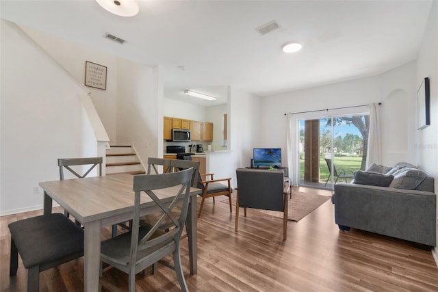 4224 Calabria Ave, Davenport, FL 33897 - dining room featuring stairway and wood finished floors