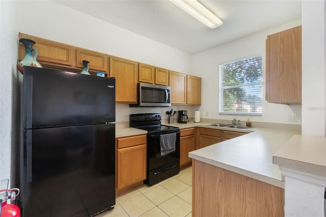 4224 Calabria Ave, Davenport, FL 33897 - kitchen with black appliances, light countertops, a peninsula, light tile patterned floors, and brown cabinets