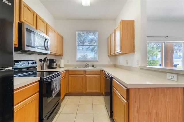 4224 Calabria Ave, Davenport, FL 33897 - kitchen featuring black appliances, light countertops, light tile patterned floors, and a peninsula