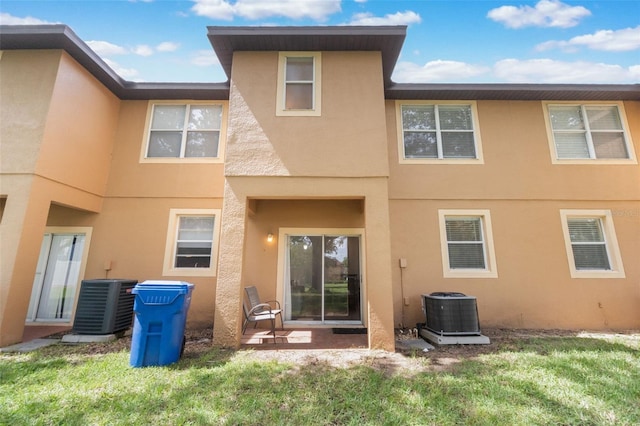 4224 Calabria Ave, Davenport, FL 33897 - rear view of property with stucco siding, a yard, and a patio area