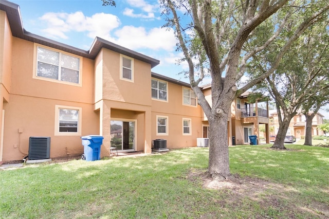 4224 Calabria Ave, Davenport, FL 33897 - rear view of property with stucco siding and a lawn