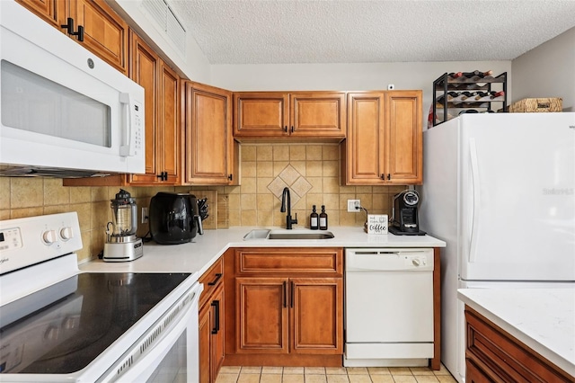 364 Northpointe Ct Unit 208, Altamonte Springs, FL 32701 - kitchen with white appliances, a textured ceiling, light countertops, brown cabinets, and backsplash