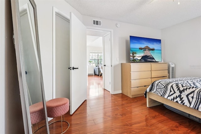 364 Northpointe Ct Unit 208, Altamonte Springs, FL 32701 - bedroom with wood finished floors and a textured ceiling