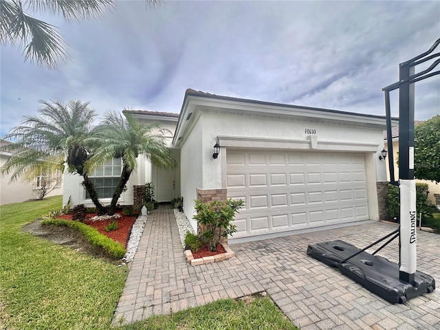 10110 SW Chadwick Dr, Port St Lucie, FL 34987 - view of front of property with stucco siding, decorative driveway, and a garage