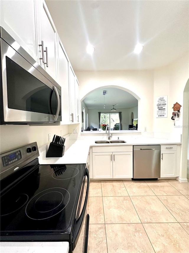 10110 SW Chadwick Dr, Port St Lucie, FL 34987 - kitchen featuring appliances with stainless steel finishes, white cabinets, light countertops, and light tile patterned floors