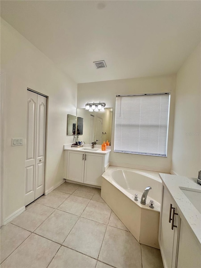 10110 SW Chadwick Dr, Port St Lucie, FL 34987 - full bath featuring two vanities, a bath, and tile patterned floors
