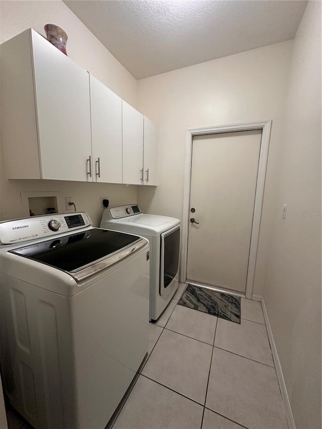 10110 SW Chadwick Dr, Port St Lucie, FL 34987 - washroom featuring independent washer and dryer, cabinet space, and light tile patterned flooring